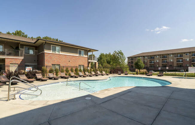 Resort-style pool with lounge chairs at Villas of Omaha in northwest Omaha NE 68116
