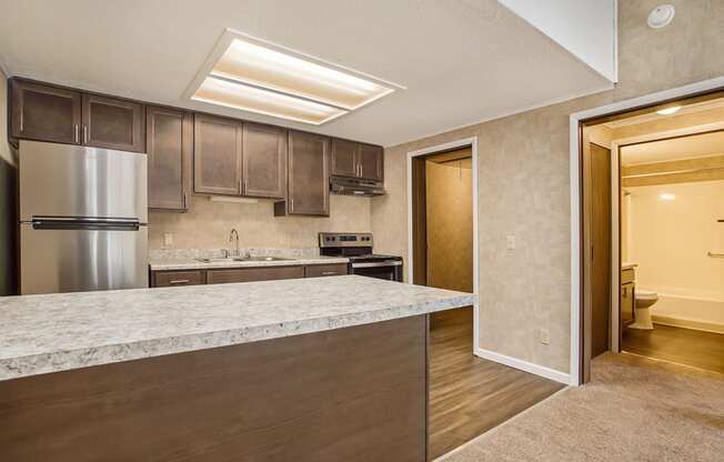 a kitchen with a large island and stainless steel appliances