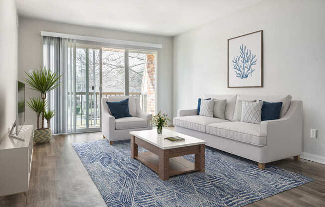 a living room with a couch and chair and a coffee table