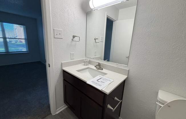 an empty bathroom with a sink and a toilet
