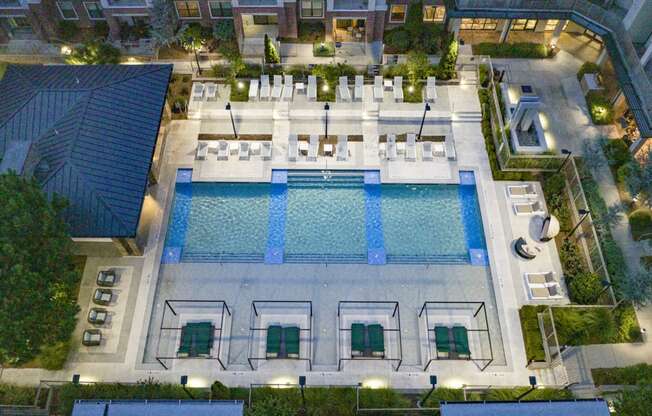 an aerial view of resort style pool at night at The Hendrix, Georgia