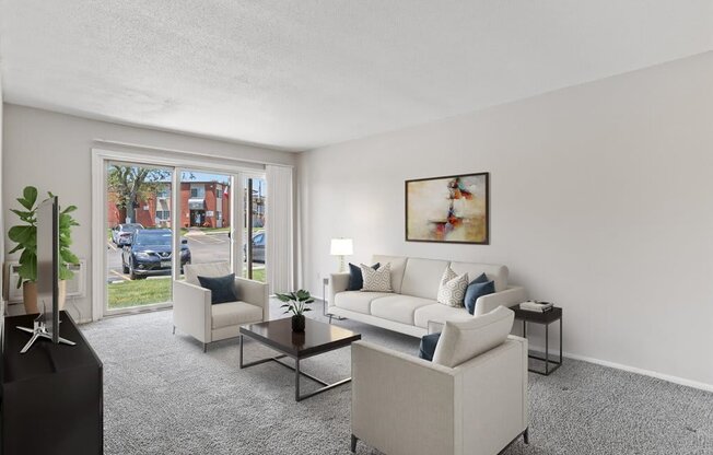 the living room of an apartment with a couch and chairs
