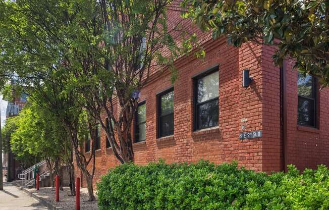 a red brick building with trees in front of it