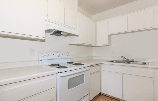 a white stove top oven sitting inside of a kitchen