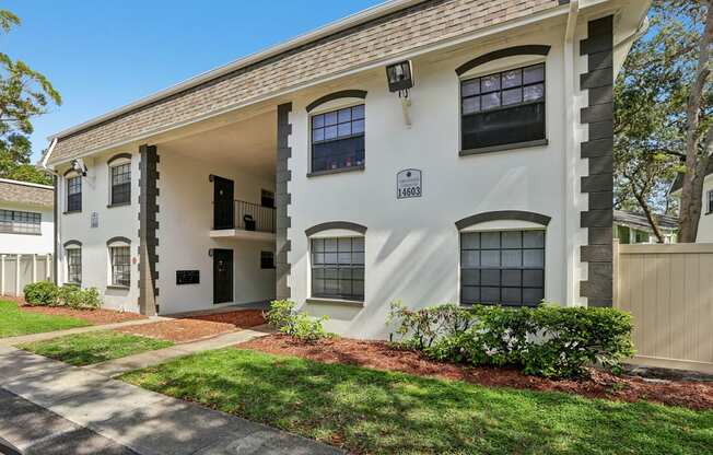 A white building with black trim and windows is labeled 16483.