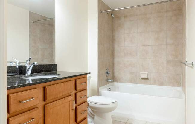 A bathroom with a white toilet and a white bathtub.
