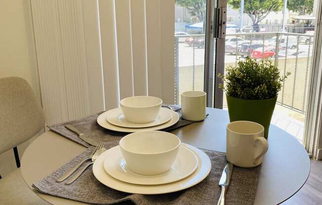 a dining room with a table and chairs and a balcony