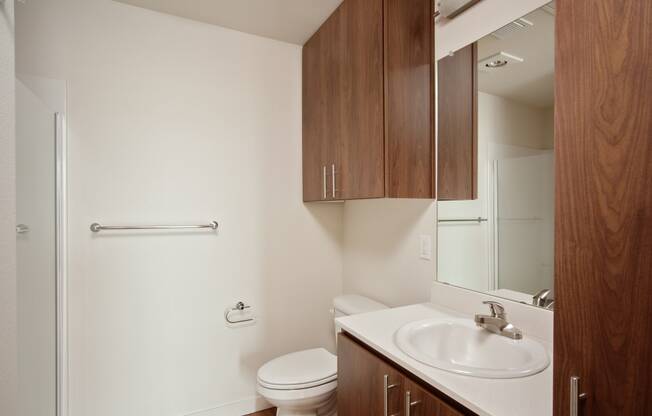 an empty bathroom with a sink toilet and mirror
