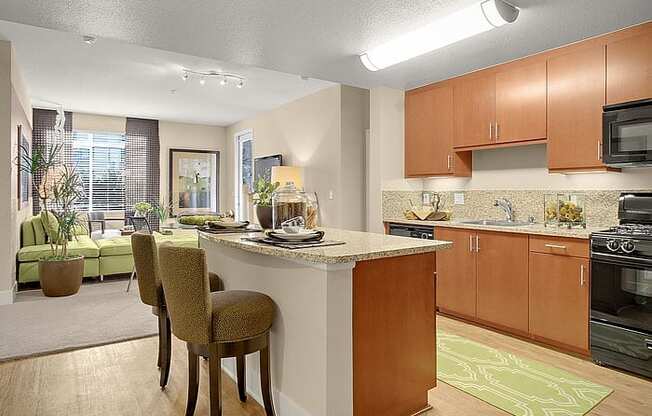 a kitchen with a center island next to a living room