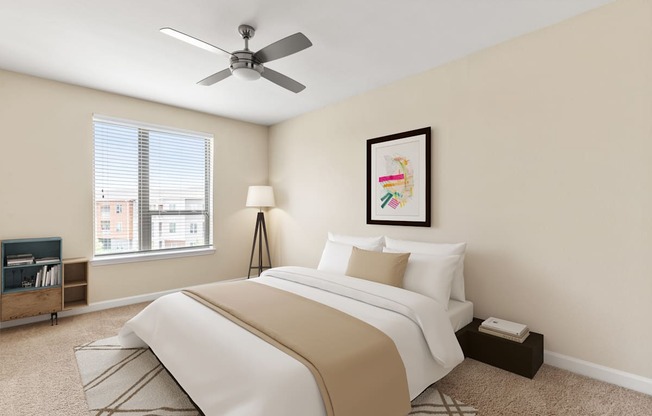 A bedroom with a large bed and a ceiling fan.
