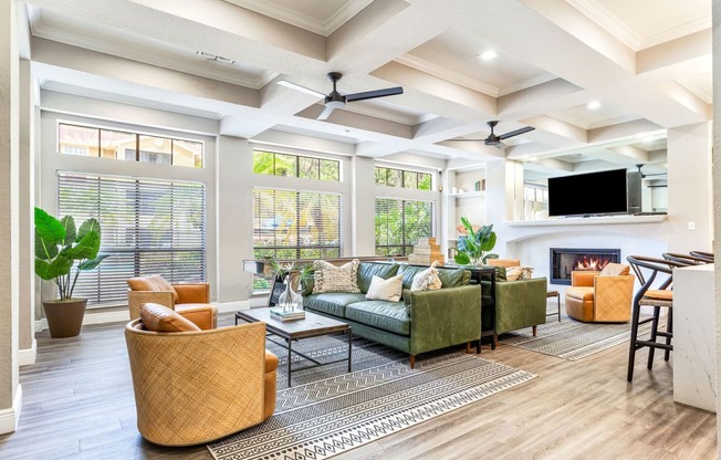 a living room with couches and chairs and a fireplace