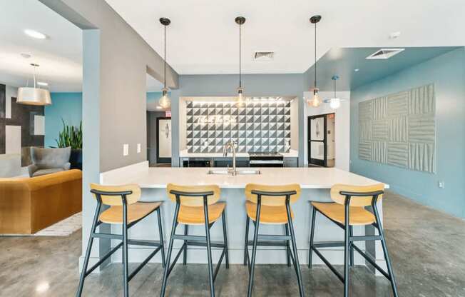 A modern kitchen with a bar area and stools.