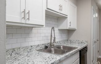 a kitchen with a sink and white cabinetsat Glen Hollow,Decatur, GA, 30034