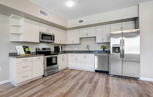 a kitchen with white cabinets and stainless steel appliances