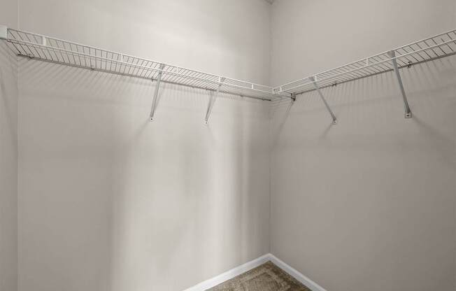 A white closet with a metal rack.