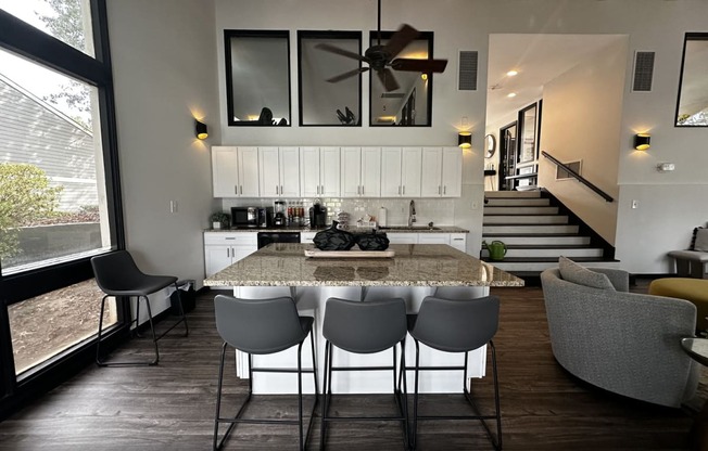 a kitchen and dining room with a marble table and chairs