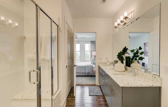 a bathroom with a glass shower stall