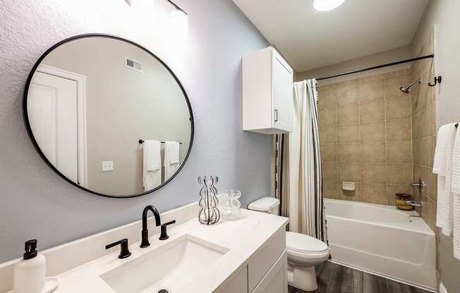A bathroom with a white sink and toilet.