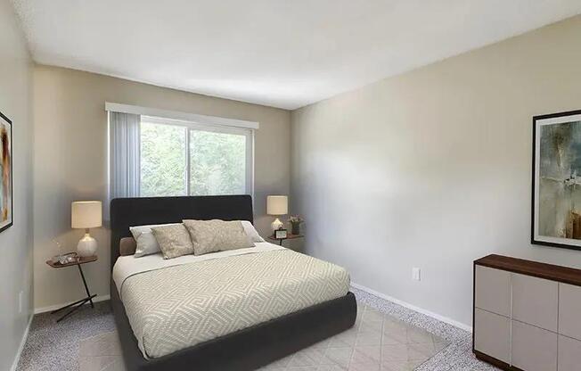 A bedroom with a large bed and a window.