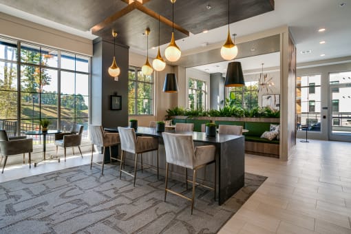 a dining room with a table and chairs and a large window