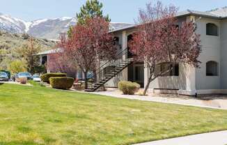 an apartment building with mountains in the background