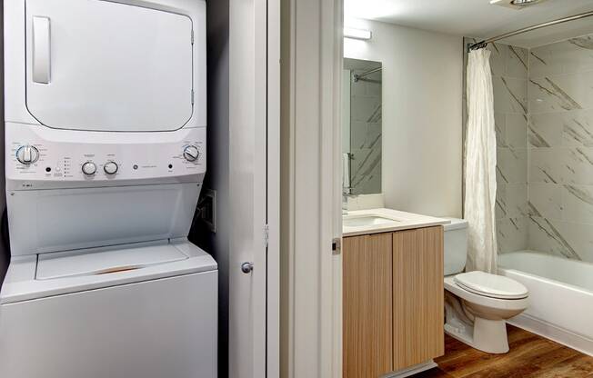 Washer/dryer next to full bath