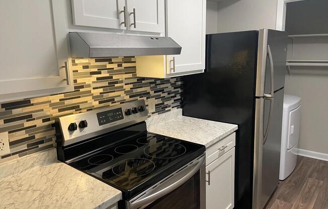 a stove top oven sitting inside of a kitchen