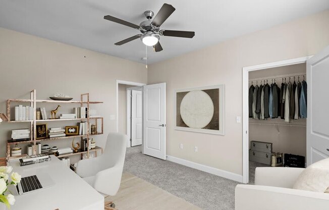 an office with a ceiling fan and a closet