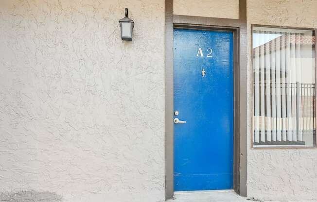 a blue door on the side of a building