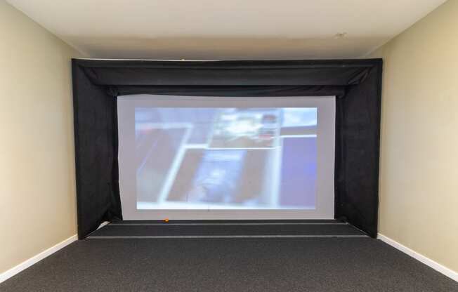 a large projection screen in a room with a carpeted floor