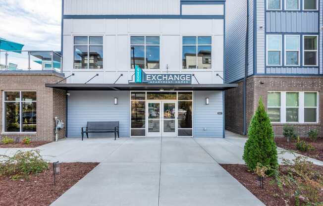 the entrance to a building with a bench in front of it