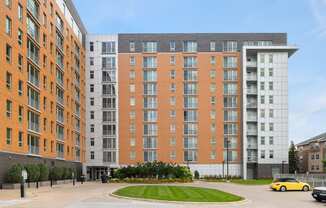 a large apartment building on a street with a parking lot