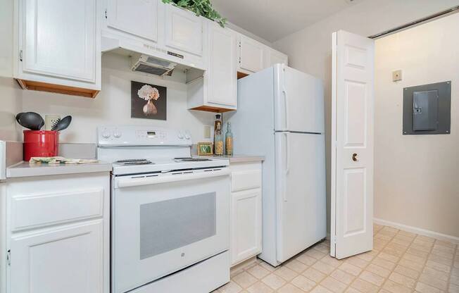A white kitchen with a fridge, oven, and microwave.at Camden Place, Ohio 43016