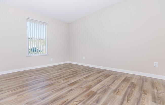 a large empty room with a wooden floor