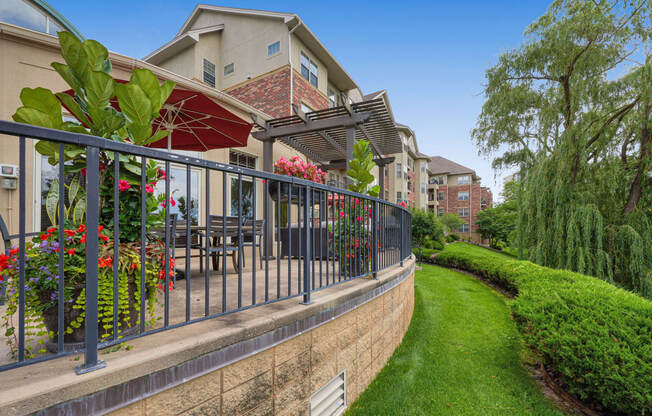 a patio with tables and chairs and a fence