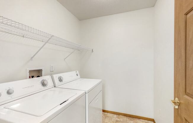 a washer and dryer in a laundry room with a door