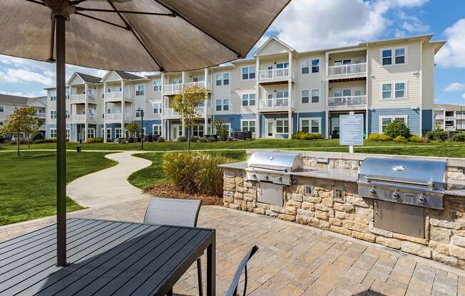A patio with a table and chairs under a canopy.
