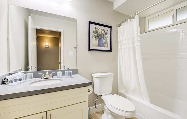 Edge on the Boulevard - White Bathroom with a Mirrored Vanity at The Edge on the Boulevard, Fremont California
