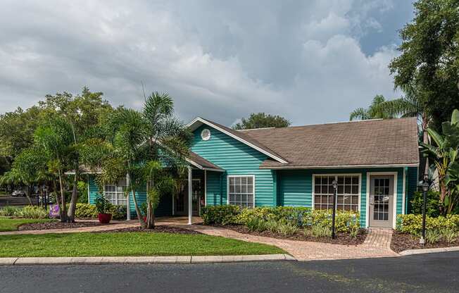 a blue house with palm trees in front of it