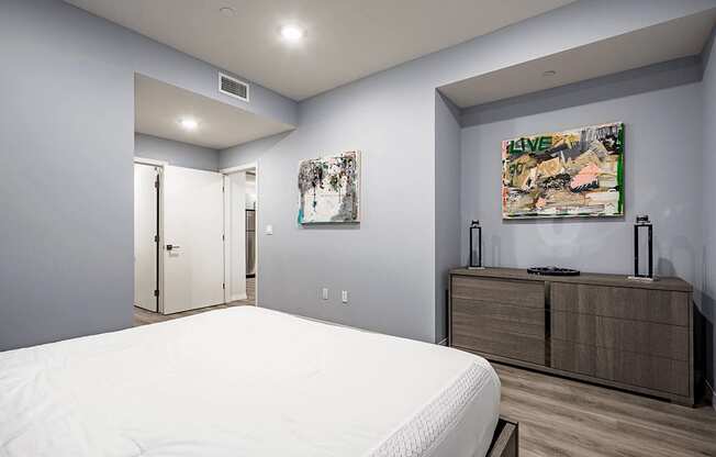 Bedroom with custom wall paint, laminate flooring,  recessed lighting