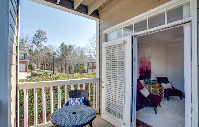 View of Patio, Showing Outdoor Furniture and View of Living Room at Retreat at Peachtree City Apartments