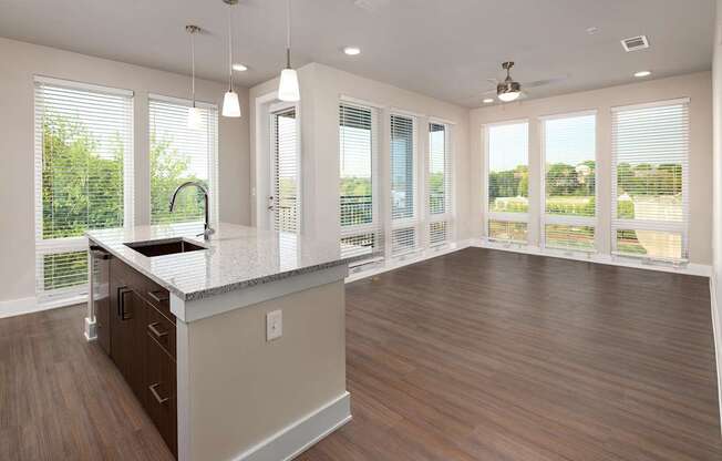 A modern kitchen with stainless steel appliances and floor to ceiling windows