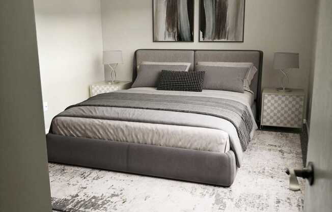 A bedroom with a large bed and a painting on the wall.