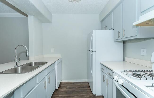 a kitchen with a sink and a mirror