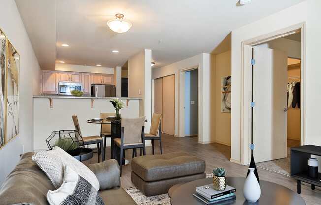 Living room looking towards the dining table and kitchen, bedroom doors on the right with a couch and coffee table on the left at 6 Wood Flats, Washington
