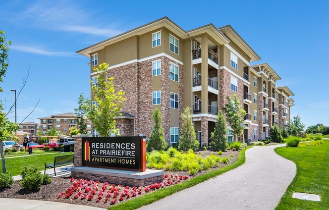A sign in front of a building that says Residences at Prairiefire.