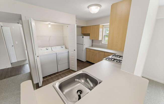 A kitchen with a washer and dryer at Stoney Pointe Apartment Homes, Kansas
