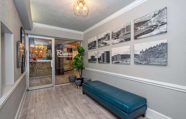 a hallway with a bench and pictures on the wall