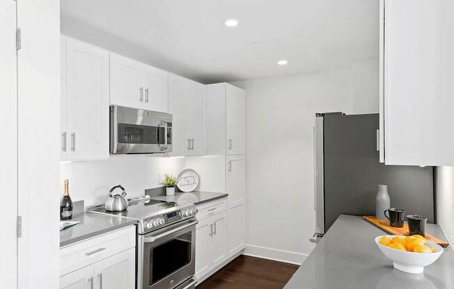 Kitchen with appliances white interior at 65 Bay Street, Jersey City, NJ