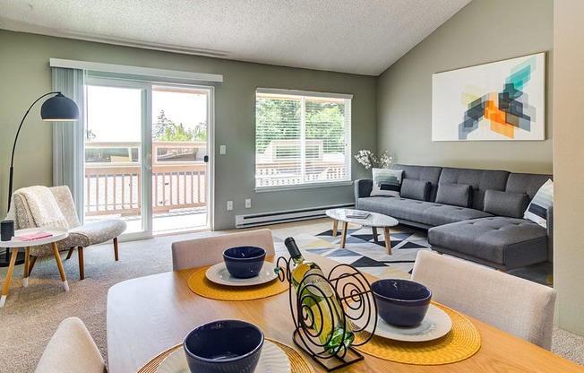 a living room with a table and chairs with a couch in the background at The Bluffs at Mountain Park, Oregon, 97035